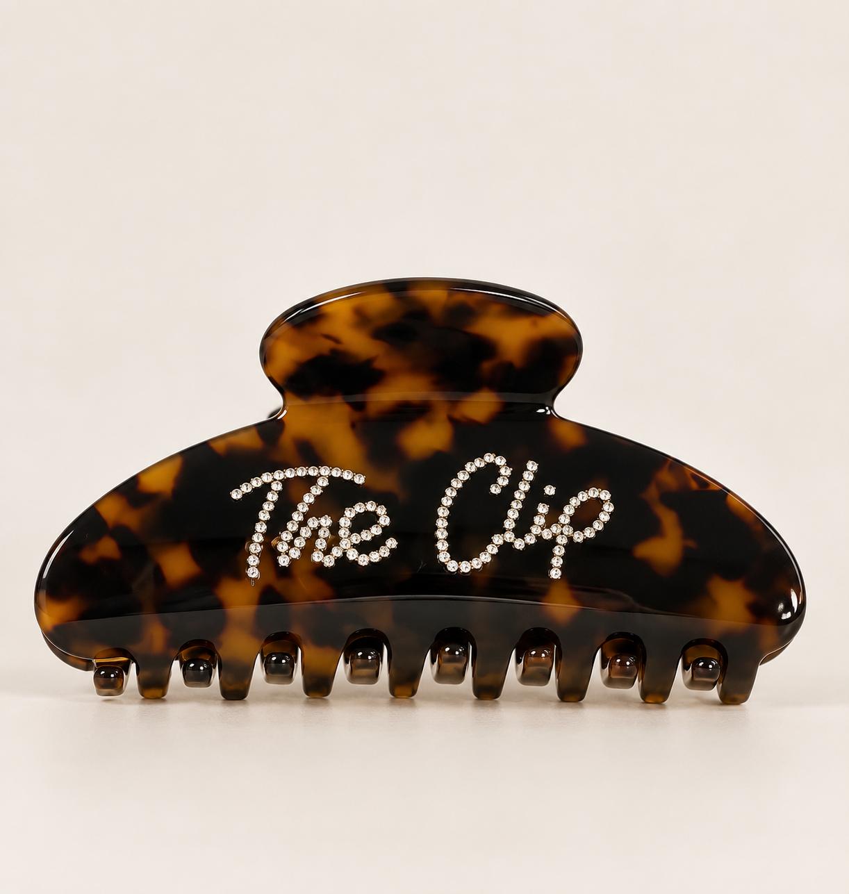 Clema de par The Clip din acetat tortoiseshell, cu logo Dollie din cristale